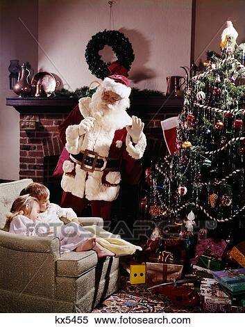 1960s 2 children boy girl sleep chair fireplace christmas eve santa waves hand tree gifts toys night before xmas View Large Photo Image Stock Photography - 1960s 2 children boy girl sleep chair fireplace christmas eve santa waves hand tree gifts toys night before xmas. Fotosearch