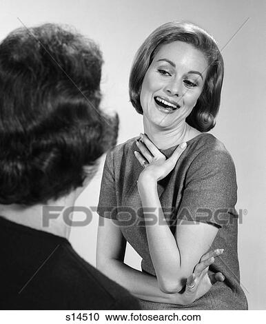 1960s 2 women talking one facing camera pleased satisfied proud smiling facial expression View Large Photo Image Stock Image - 1960s 2 women talking one facing camera pleased satisfied proud smiling facial expression. Fotosearch
