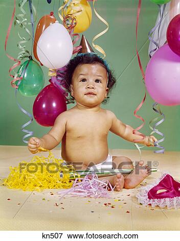 1960s african-american baby boy wearing party hat balloons streamers noisemaker mask View Large Photo Image Stock Photo - 1960s african-american baby boy wearing party hat balloons streamers noisemaker mask. Fotosearch