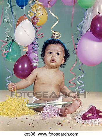 1960s african-american baby boy wearing party hat balloons streamers noisemaker mask View Large Photo Image Stock Photograph - 1960s african-american baby boy wearing party hat balloons streamers noisemaker mask. Fotosearch