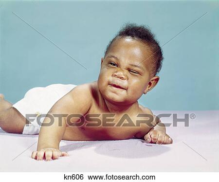 1960s african-american baby boy wearing diaper winking one eye closed View Large Photo Image Stock Photograph - 1960s african-american baby boy wearing diaper winking one eye closed. Fotosearch