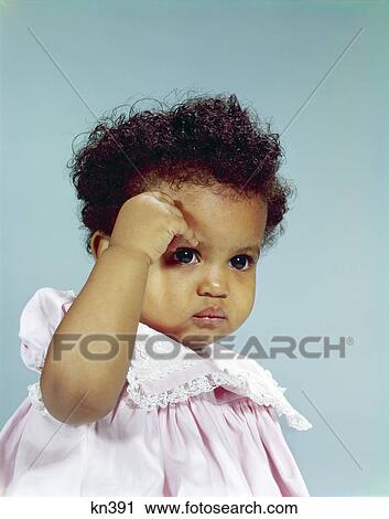1960s african-american baby girl toddler frowning gesturing with hand to forehead serious expression portrait View Large Photo Image Stock Image - 1960s african-american baby girl toddler frowning gesturing with hand to forehead serious expression portrait. Fotosearch