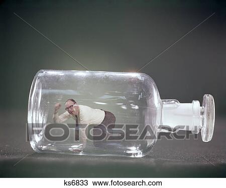 1960s angry man on hands & knees trapped inside glass bottle View Large Photo Image Stock Image - 1960s angry man on hands & knees trapped inside glass bottle. Fotosearch