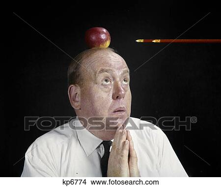 Picture - 1960s anxious business man praying looking up at arrow directed apple top head symbolic william tell. Fotosearch