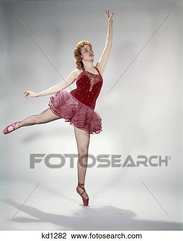 1960s awkward teen girl red velvet costume pink net tutu attempting arabesque en pointe View Large Photo Image Stock Image - 1960s awkward teen girl red velvet costume pink net tutu attempting arabesque en pointe. Fotosearch