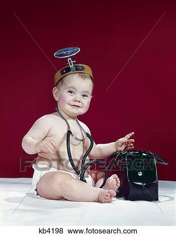 1960s baby as medical doctor with black bag wearing stethoscope & opthalmoscope View Large Photo Image Stock Photo - 1960s baby as medical doctor with black bag wearing stethoscope & opthalmoscope. Fotosearch