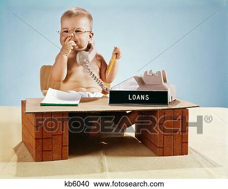 1960s baby businessman diaper sitting at toy desk loans bank sign wearing eyeglasses talking on telephone View Large Photo Image Stock Image - 1960s baby businessman diaper sitting at toy desk loans bank sign wearing eyeglasses talking on telephone. Fotosearch