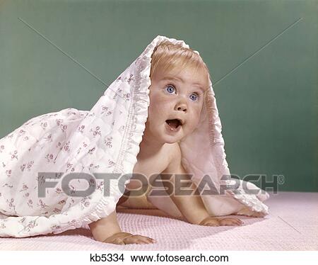 1960s baby crawling and peeking out from under a blanket View Large Photo Image Picture - 1960s baby crawling and peeking out from under a blanket. Fotosearch