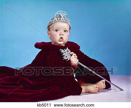 1960s baby dressed as royal queen in red velvet robe cloak cape rhinestone tiara crown and scepter wand View Large Photo Image Stock Image - 1960s baby dressed as royal queen in red velvet robe cloak cape rhinestone tiara crown and scepter wand. Fotosearch