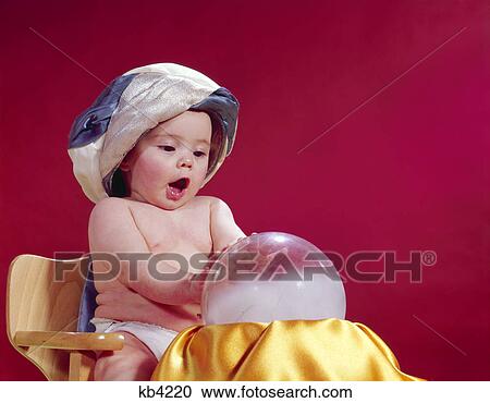 1960s baby fortune teller wearing turban seated with crystal ball View Large Photo Image Stock Image - 1960s baby fortune teller wearing turban seated with crystal ball. Fotosearch