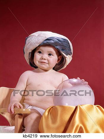 1960s baby fortune teller wearing turban seated with crystal ball View Large Photo Image Stock Photo - 1960s baby fortune teller wearing turban seated with crystal ball. Fotosearch