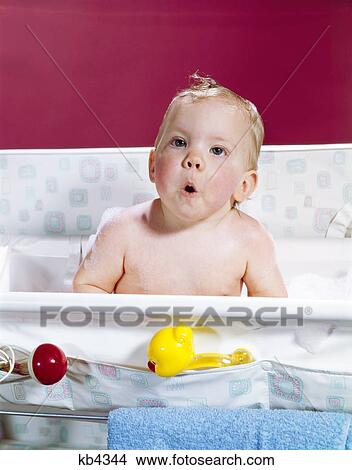 1960s baby in layette bath making funny face View Large Photo Image Picture - 1960s baby in layette bath making funny face. Fotosearch
