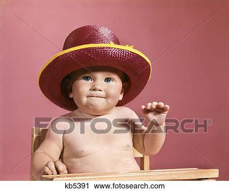 1960s baby making face wearing red straw hat View Large Photo Image Stock Image - 1960s baby making face wearing red straw hat. Fotosearch