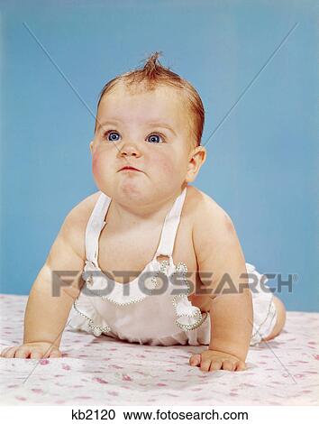 1960s baby making funny face pushed up on arms crawling forward View Large Photo Image Stock Image - 1960s baby making funny face pushed up on arms crawling forward. Fotosearch