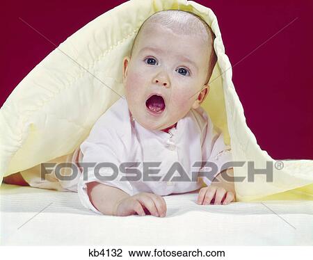 1960s baby mouth wide open peeking out from under yellow blanket surprised facial expression View Large Photo Image Stock Image - 1960s baby mouth wide open peeking out from under yellow blanket surprised facial expression. Fotosearch