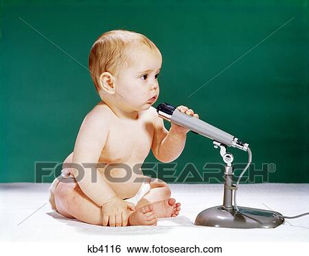 1960s baby talking into holding microphone View Large Photo Image Stock Photograph - 1960s baby talking into holding microphone. Fotosearch
