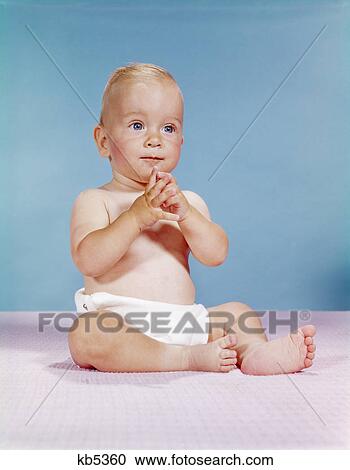 1960s baby wearing cloth diaper sitting with hands together thoughtful pose expression View Large Photo Image Stock Image - 1960s baby wearing cloth diaper sitting with hands together thoughtful pose expression. Fotosearch