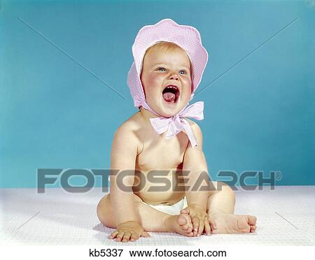 1960s baby wearing red checked bonnet hat laughing View Large Photo Image Stock Photo - 1960s baby wearing red checked bonnet hat laughing. Fotosearch