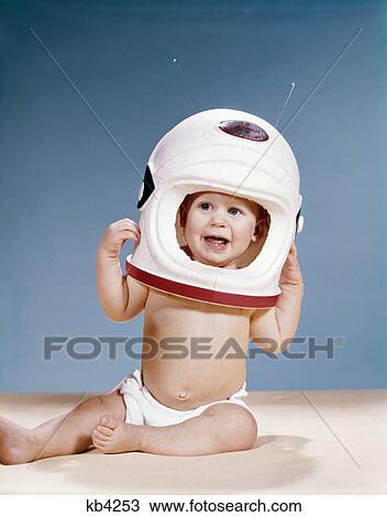 1960s baby wearing styrofoam astronaut helmet View Large Photo Image Stock Image - 1960s baby wearing styrofoam astronaut helmet. Fotosearch