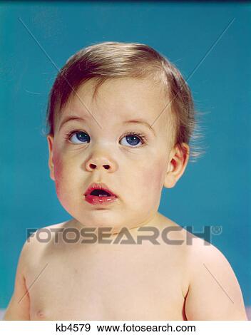 1960s baby with uncertain facial expression eyes looking up and to the side View Large Photo Image Stock Photo - 1960s baby with uncertain facial expression eyes looking up and to the side. Fotosearch