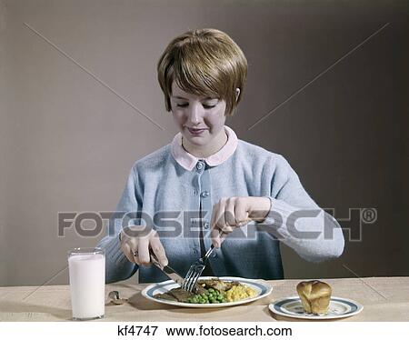 1960s blond teenage girl eating wholesome dinner View Large Photo Image Stock Photo - 1960s blond teenage girl eating wholesome dinner. Fotosearch