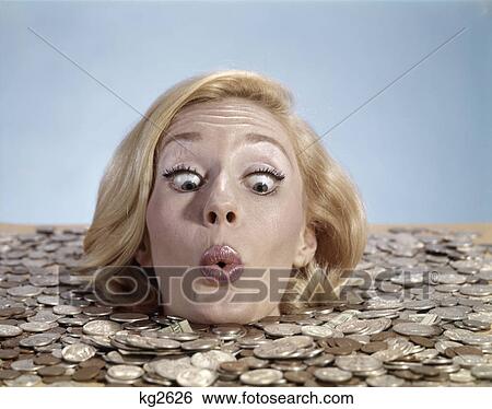 1960s blond woman funny facial expression drowning in coins up to her neck View Large Photo Image Stock Photograph - 1960s blond woman funny facial expression drowning in coins up to her neck. Fotosearch