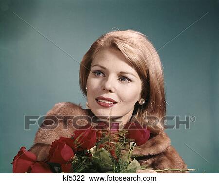 1960s blond woman wearing fur coat holding bunch of red roses View Large Photo Image Stock Image - 1960s blond woman wearing fur coat holding bunch of red roses. Fotosearch