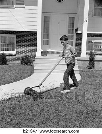1960s boy cutting mowing suburban home front yard lawn grass using push lawnmower View Large Photo Image Stock Photo - 1960s boy cutting mowing suburban home front yard lawn grass using push lawnmower. Fotosearch