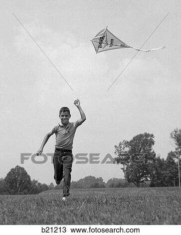 1960s boy running flying kite View Large Photo Image Stock Image - 1960s boy running flying kite. Fotosearch