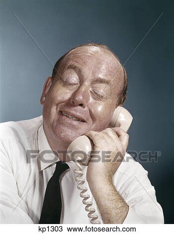 1960s business man eyes closed funny facial expression talking on telephone View Large Photo Image Stock Image - 1960s business man eyes closed funny facial expression talking on telephone. Fotosearch