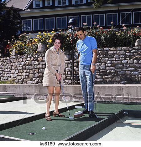 1960s couple man woman playing miniature golf View Large Photo Image Stock Photo - 1960s couple man woman playing miniature golf. Fotosearch