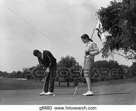 Stock Image - 1960s couple man woman put putting. Fotosearch