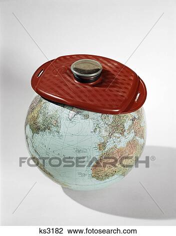 Stock Image - 1960s earth globe wear ice pack red hot-water bottle sick ailing world. Fotosearch
