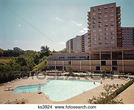 1960s elevated view swimming pool shaped like arrow in apartment building complex View Large Photo Image Picture - 1960s elevated view swimming pool shaped like arrow in apartment building complex. Fotosearch