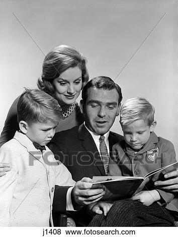 1960s family looking reading book View Large Photo Image Stock Photo - 1960s family looking reading book. Fotosearch