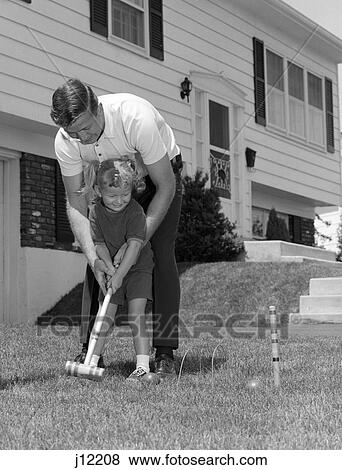 1960s family playing in yard croquet View Large Photo Image Stock Photo - 1960s family playing in yard croquet. Fotosearch
