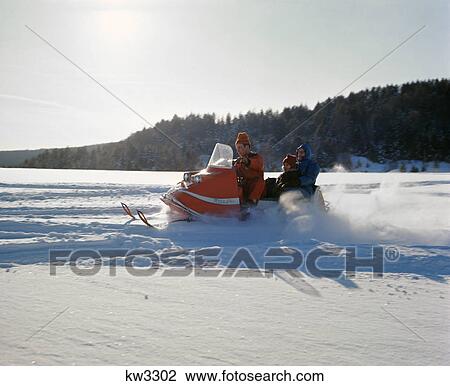 1960s family riding on snowmobile in winter snowy landscape View Large Photo Image Stock Image - 1960s family riding on snowmobile in winter snowy landscape. Fotosearch