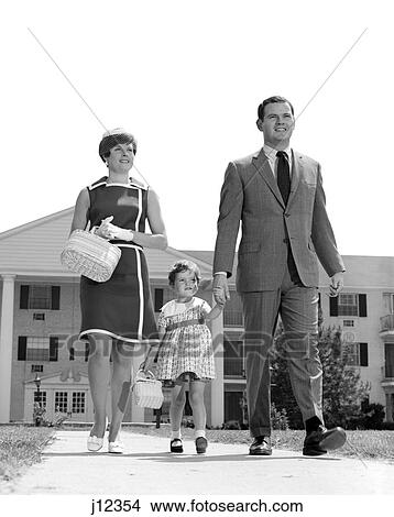 Picture - 1960s family taking a walk sidewalk. Fotosearch