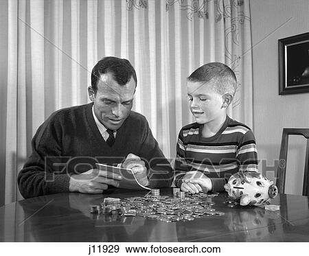 1960s father boy piggy bank count money coins View Large Photo Image Stock Photo - 1960s father boy piggy bank count money coins. Fotosearch