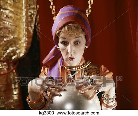 1960s female gypsy fortune teller looking into crystal ball View Large Photo Image Stock Image - 1960s female gypsy fortune teller looking into crystal ball. Fotosearch