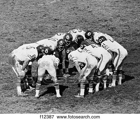 1960s football team huddle View Large Photo Image Stock Photo - 1960s football team huddle. Fotosearch