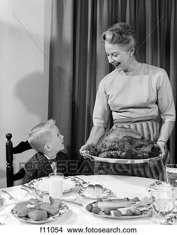1960s grandmother grandson roast turkey thanksgiving dinner View Large Photo Image Picture - 1960s grandmother grandson roast turkey thanksgiving dinner. Fotosearch