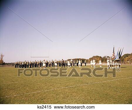 Stock Photography - 1960s high school marching band practicing on football field. Fotosearch