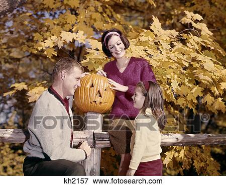 1960s jack-o'-lantern pumpkin family mother father daughter girl fence autumn fall View Large Photo Image Stock Photo - 1960s jack-o'-lantern pumpkin family mother father daughter girl fence autumn fall. Fotosearch