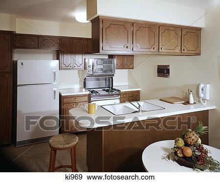 1960s Kitchen Interior With Brown Cabinets And White Counter