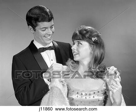 1960s male female dress formal putting on coat View Large Photo Image Stock Image - 1960s male female dress formal putting on coat. Fotosearch