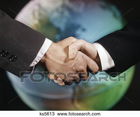 1960s male handshake in front of world globe View Large Photo Image Stock Image - 1960s male handshake in front of world globe. Fotosearch