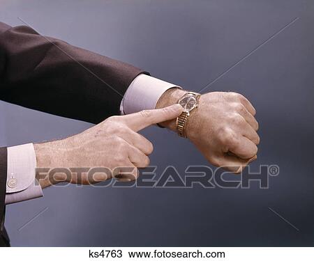 1960s man hands pointing wrist watch time View Large Photo Image Stock Image - 1960s man hands pointing wrist watch time. Fotosearch