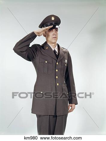 Stock Image - 1960s man in military army uniform saluting. Fotosearch