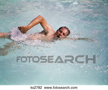 1960s man in water swimming overhand crawl stroke View Large Photo Image Stock Image - 1960s man in water swimming overhand crawl stroke. Fotosearch